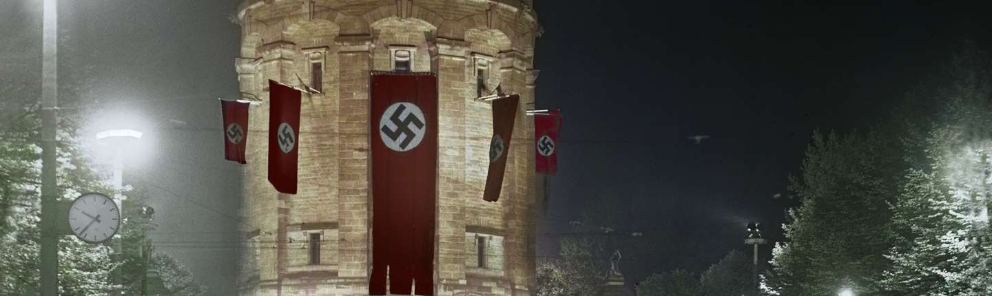 The water tower flagged with swastika flags.